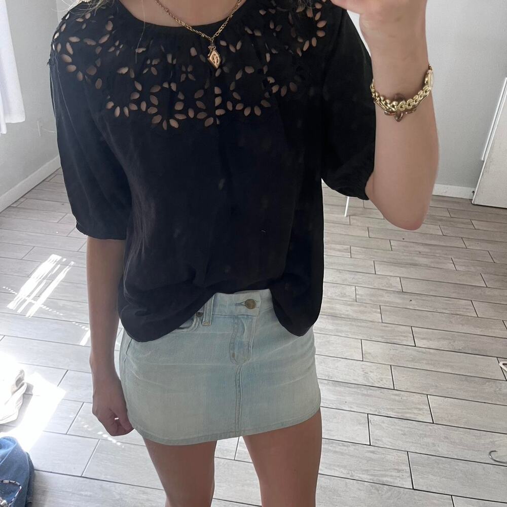 Black top with eyelet cutouts